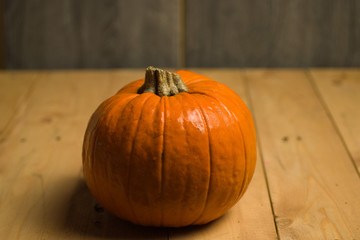 Ripe pumpkin isolated on wooden background