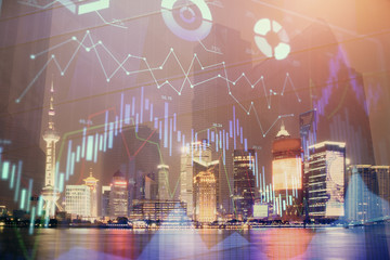 Financial graph on night city scape with tall buildings background double exposure. Analysis concept.