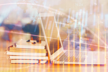 Stock market graph on background with desk and personal computer. Multi exposure. Concept of financial analysis.