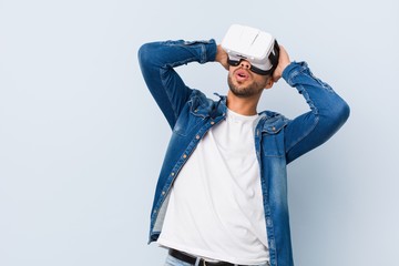 Young south-asian man playing with virtual reality glasses