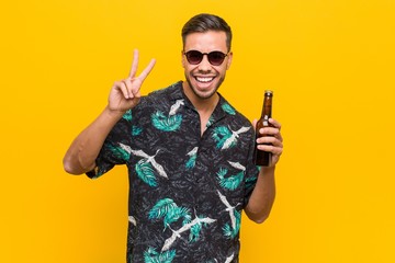 Young south-asian traveler holding a beer bottle.