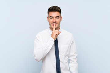 Handsome businessman over isolated blue background doing silence gesture
