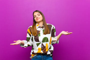young pretty woman feeling puzzled and confused, unsure about the correct answer or decision,...