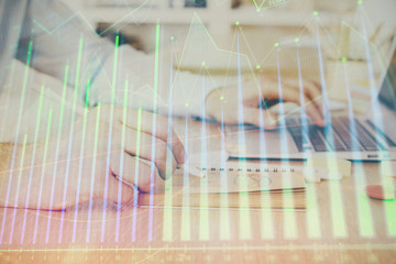Multi exposure of financial graph with man works in office on background. Concept of analysis.