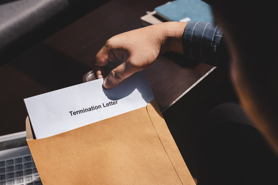 Stressed Businessman Feeling Down After Received Termination Of Employment Form In Paper Brown Envelope.