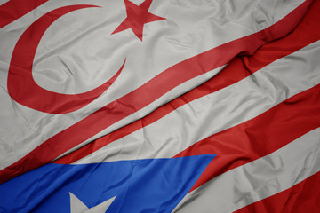 waving colorful flag of puerto rico and national flag of northern cyprus.