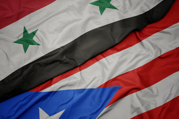 waving colorful flag of puerto rico and national flag of syria.