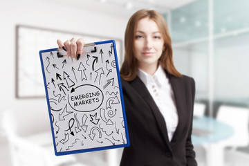 Business, technology, internet and network concept. Young businessman shows a keyword: Emerging...