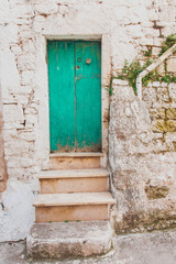 Fototapeta na wymiar old wooden door – Streets and doors of Puglia, Italy
