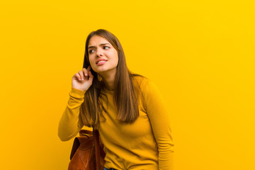 young pretty woman looking serious and curious, listening, trying to hear a secret conversation or...