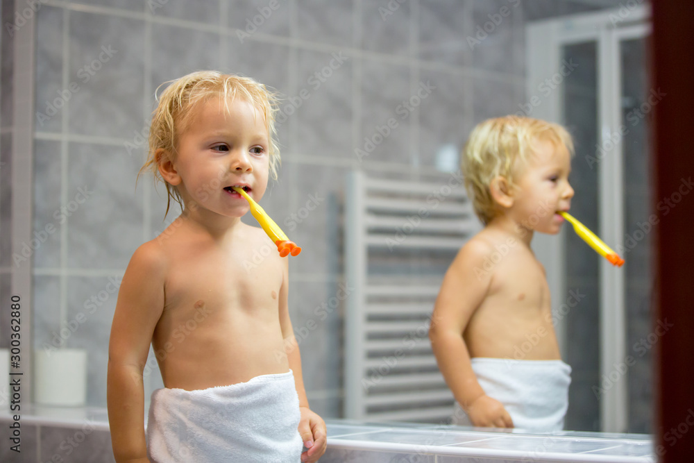 Sticker Sweet toddler boy, brushing his teeth in bathroom in the evening after bath