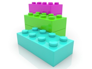 Different colored toy bricks on white background