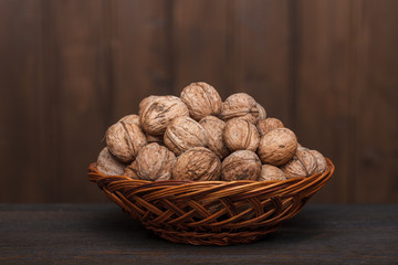 walnuts in a basket on a wooden table