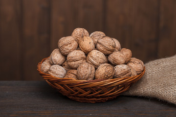 walnuts in a basket on a wooden table