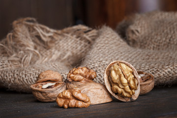 Fototapeta na wymiar walnuts in a basket on a wooden table