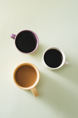 Cups of coffee on light background
