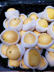 The top view of the yellow barrow fruit in a black basket