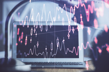 Obraz premium Stock market graph and table with computer background. Double exposure. Concept of financial analysis.