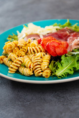 tasty pasta with roast ham on the table