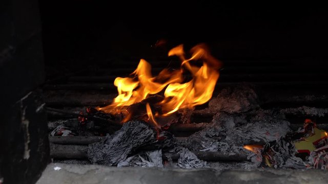 View inside a chinese temple furnace, burning joss papers as part of worship and prayers