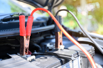 Close up battery jumper cables connect to car battery for charging dead battery