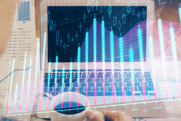 Forex market graph hologram and personal computer on background. Multi exposure. Concept of investment.