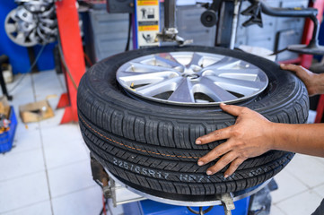 Mechanic replace new tire on rim by machine