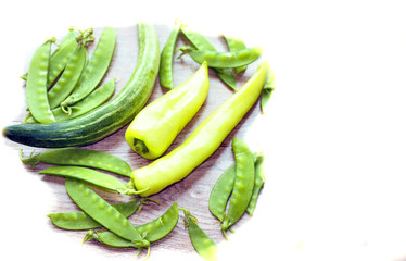 fresh green vegetables on a light background, peas, peppers, cabbage
