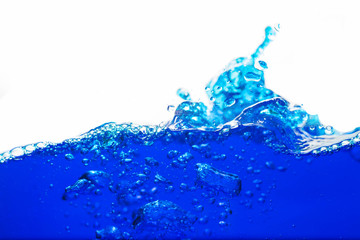 Close up blue Water splash with bubbles on white background