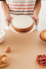 Male pastry chef holding sponge cake. The concept of homemade pastry, cooking cakes.