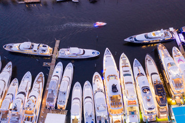 Ariel direct overhead shot of luxury Super yachts lit at night Fort Lauderdale international boat...