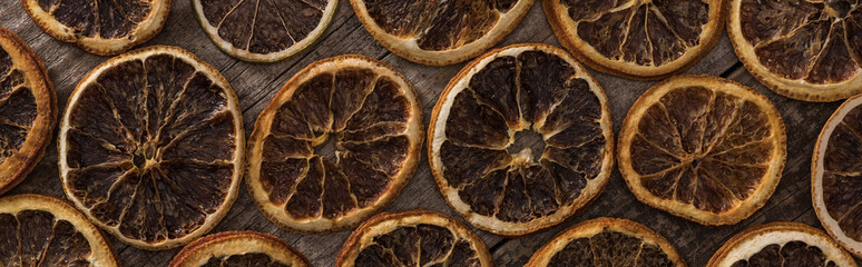 top view of dried orange slices on wooden background, panoramic shot