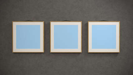 Three Empty Modern Style Frames On The Grey Wall