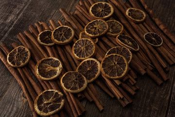 dried orange slices and cinnamon on wooden background