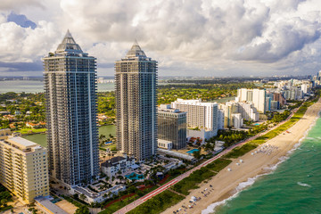 Fototapeta na wymiar Aerial photo Blue and Green Diamond highrise modern upscale condominium on the ocean