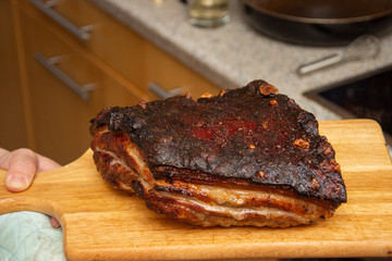 Large piece of fried pork, on a wooden platter