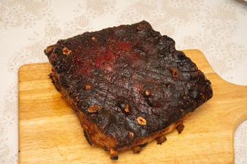 Large piece of fried pork, on a wooden platter