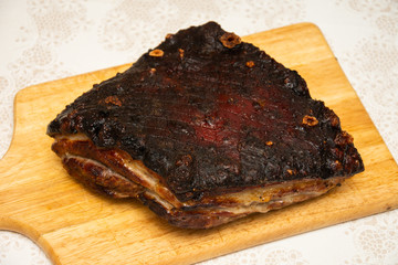 Large piece of fried pork, on a wooden platter