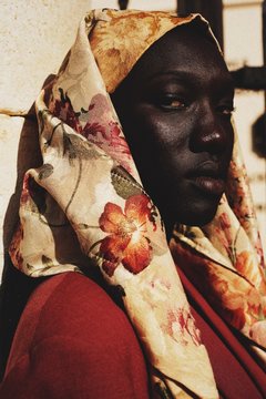 Close up of woman wearing floral headscarf
