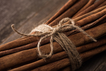 close up view of cinnamon sticks in bunch on wooden rustic table