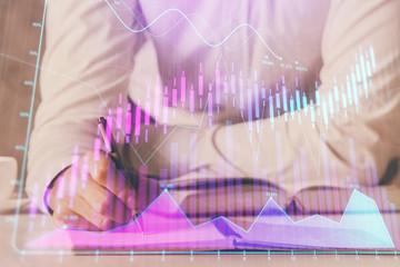 Financial trading chart double exposure with man desktop background.