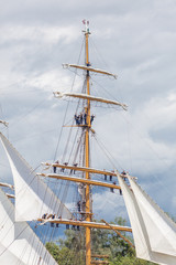 Sailors standing up in the yards of tall ship Eagle, sailing on the Seine River, Armada 2019, Normandy, France