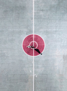 Aerial view of person standing in the center circle of basketball court