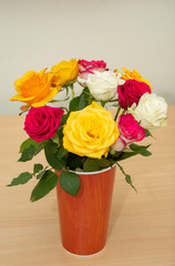 bouquet of roses in a plastic vase, cardboard