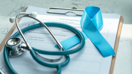 Blue awareness ribbon for prostate cancer, men health and diabetes in November with light blue bow...