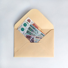 Banknotes of rubles, cash money in envelope on white background. Money savings concept.