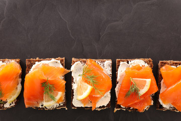 festive canape with cream and salmon, top view