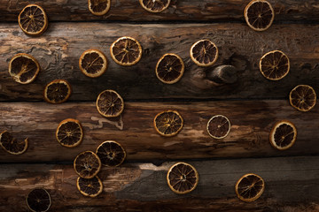 top view of dried citrus slices on wooden background