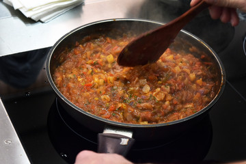 cooking vegetable sauce in a pan