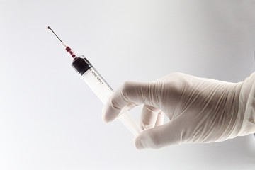 syringe in hand isolated on white background